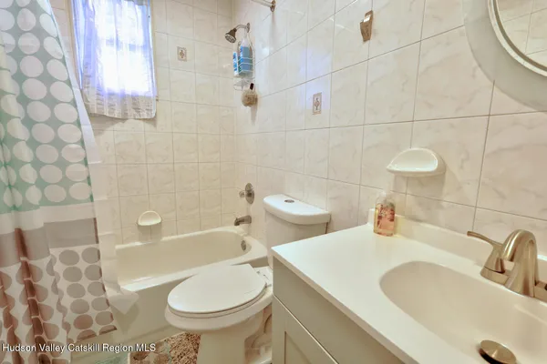 an aerial view of a house with a yard and lake view