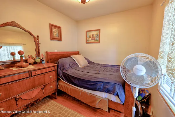an aerial view of a house with a yard and large trees
