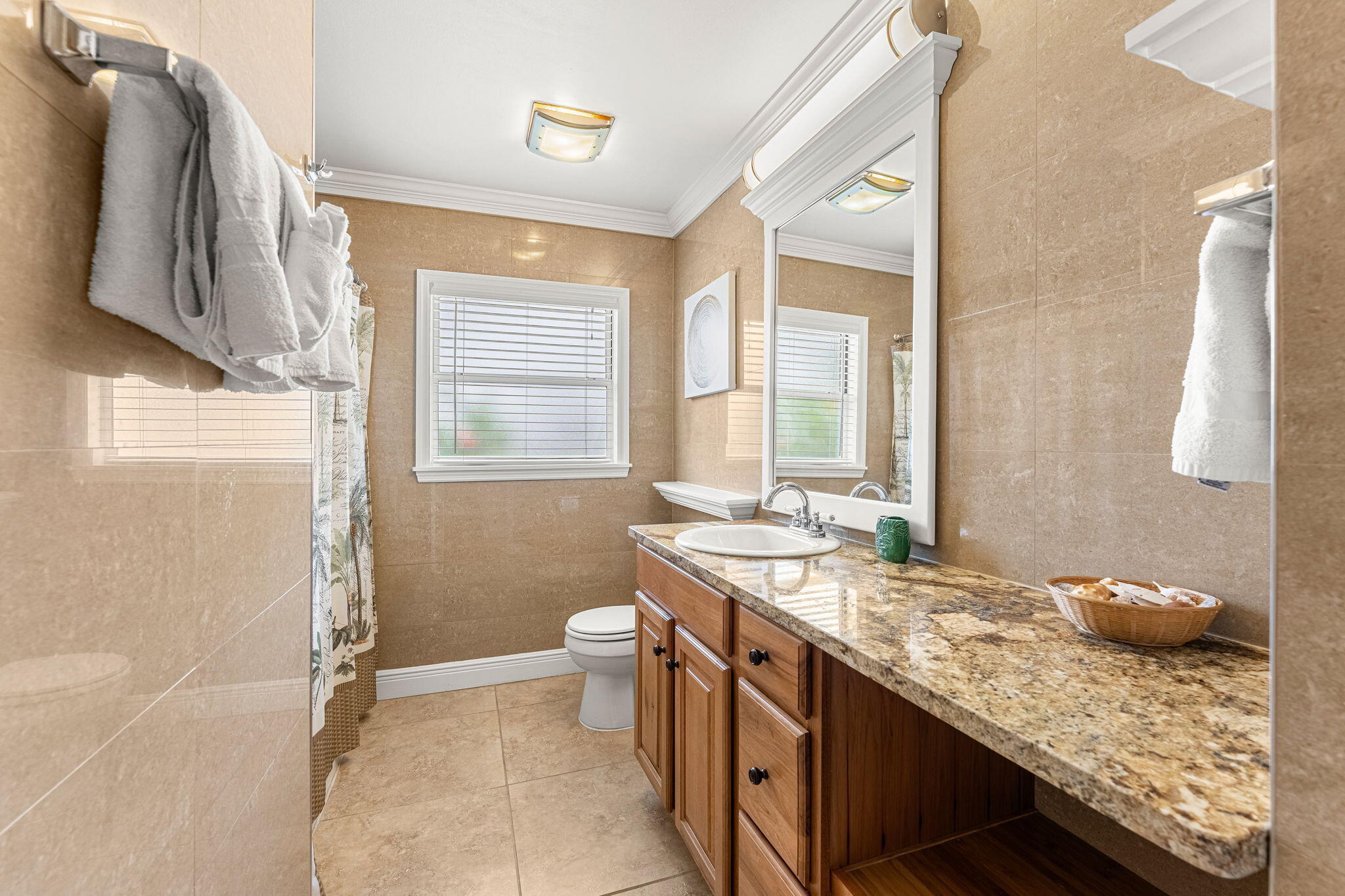 428 Dempsey Drive Cocoa Beach, FL 32931 - Photo 13 of 25 a bathroom with a granite countertop sink a toilet and a shower