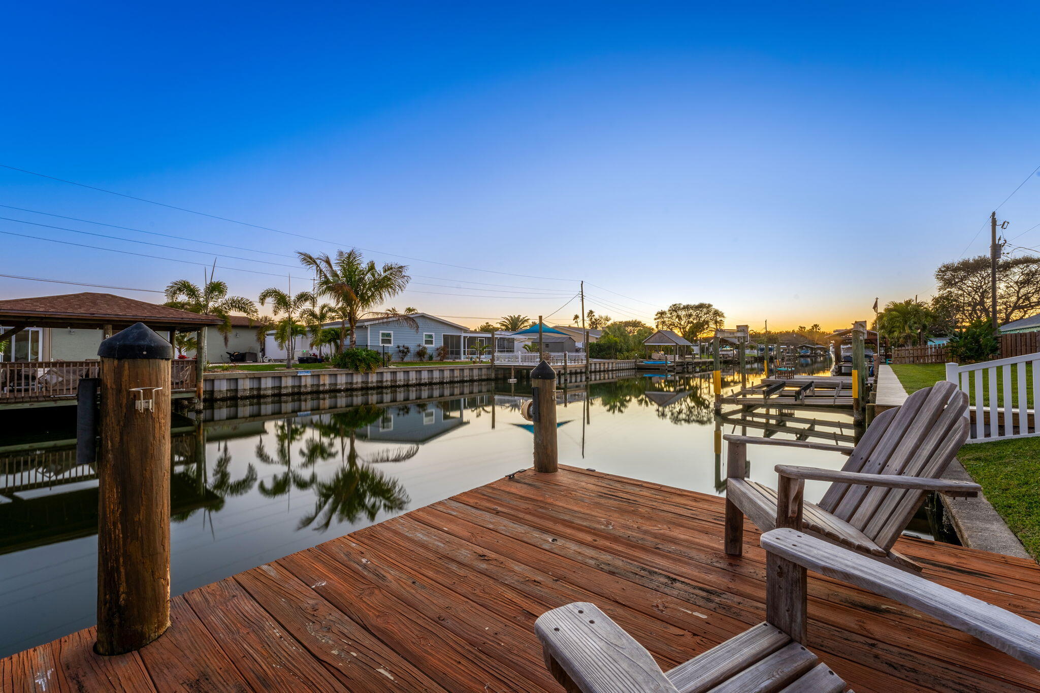 428 Dempsey Drive Cocoa Beach, FL 32931 - Photo 18 of 25 a view of a balcony with wooden floor and outdoor seating