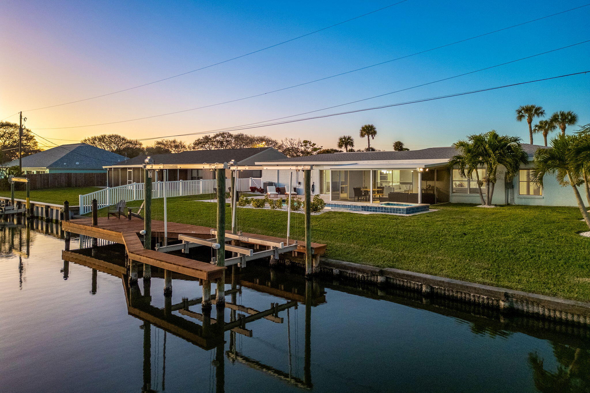 428 Dempsey Drive Cocoa Beach, FL 32931 - Photo 19 of 25 a view of a swimming pool with a table and chairs