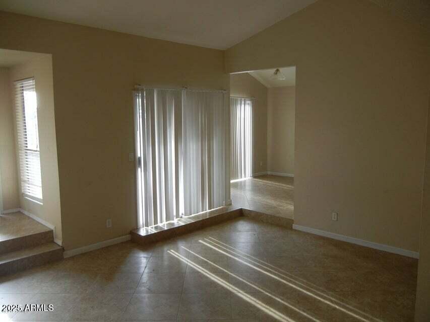 1849 East Kirkland Lane Tempe, AZ 85288 - Photo 3 of 12 an empty room with wooden floor and windows