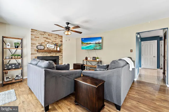 a living room with furniture a flat screen tv and a fireplace