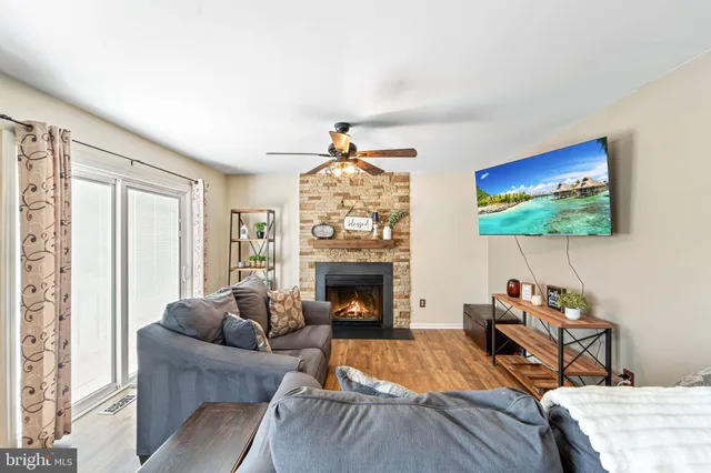 a living room with furniture a fireplace and a flat screen tv