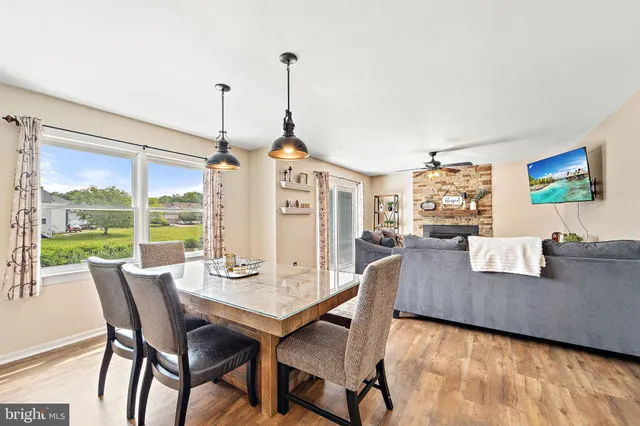 a view of a dining room with furniture large windows and wooden floor