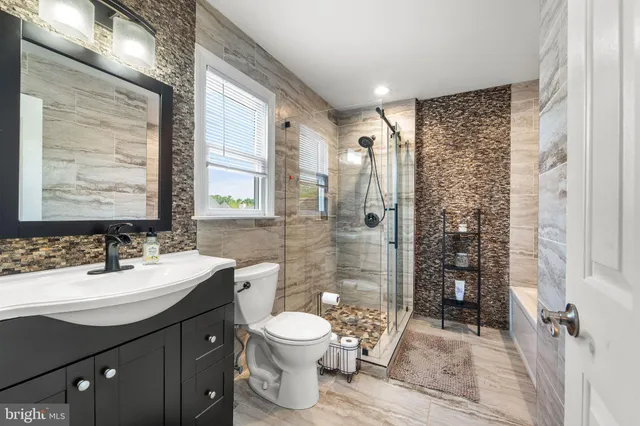a bathroom with a bathtub and shower