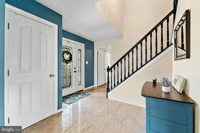 a view of a hallway with entryway wooden floor and front door