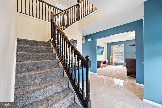 a view of staircase with wooden floor and a rug