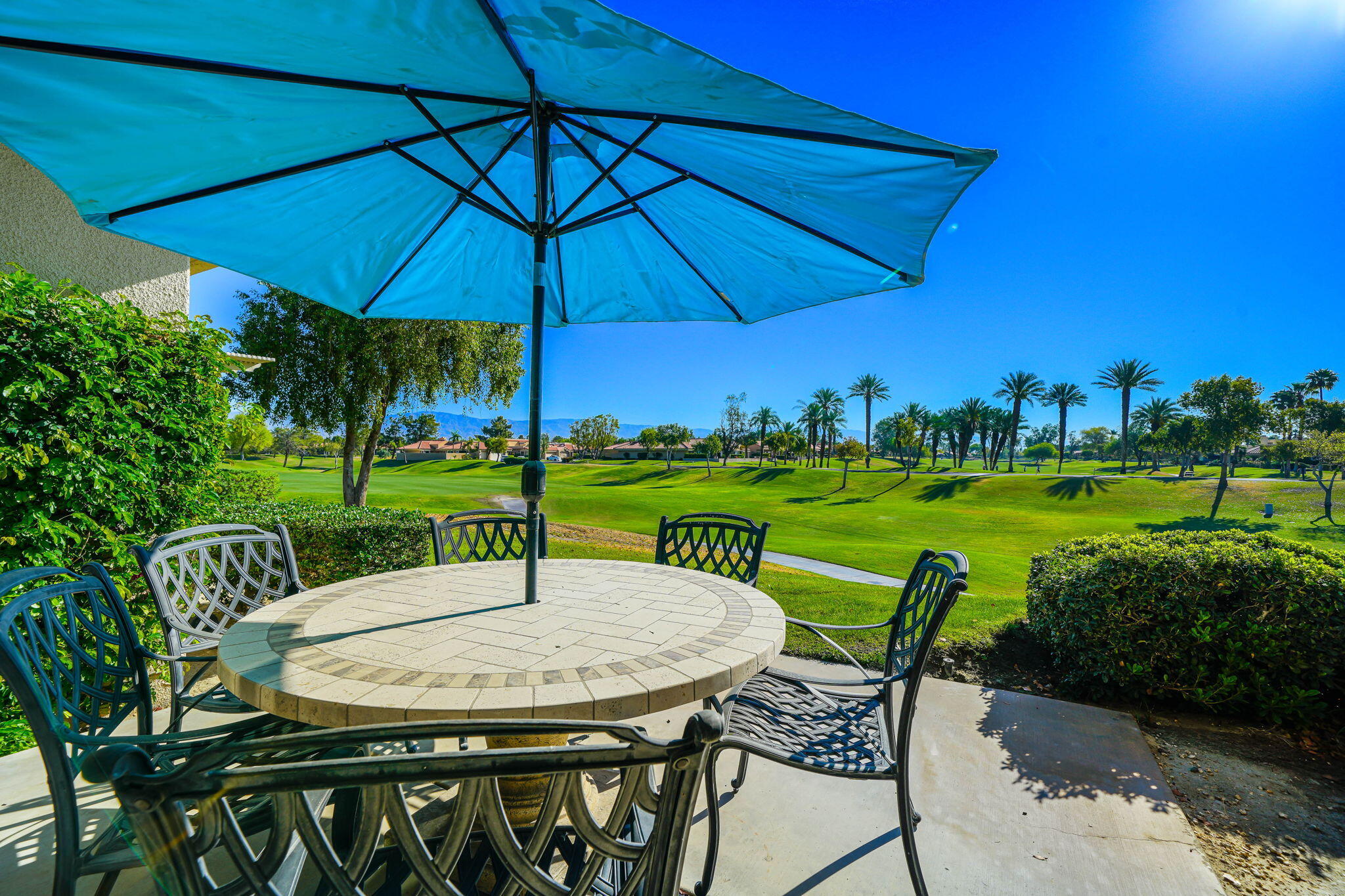 a view of a table and chairs under an umbrella