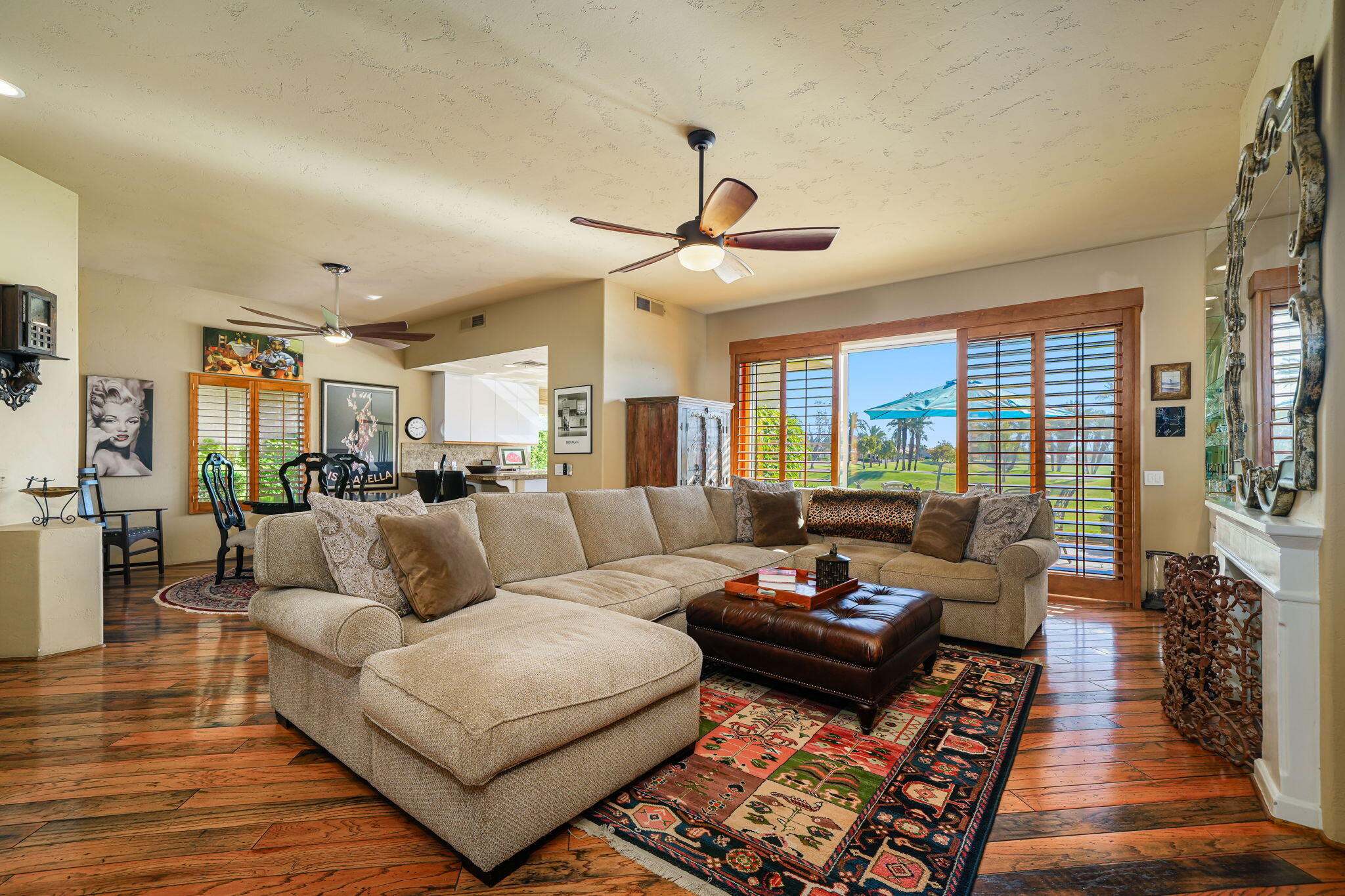 55 Colonial Drive Rancho Mirage, CA 92270 - Photo 14 of 31 a living room with furniture ceiling fan and a rug