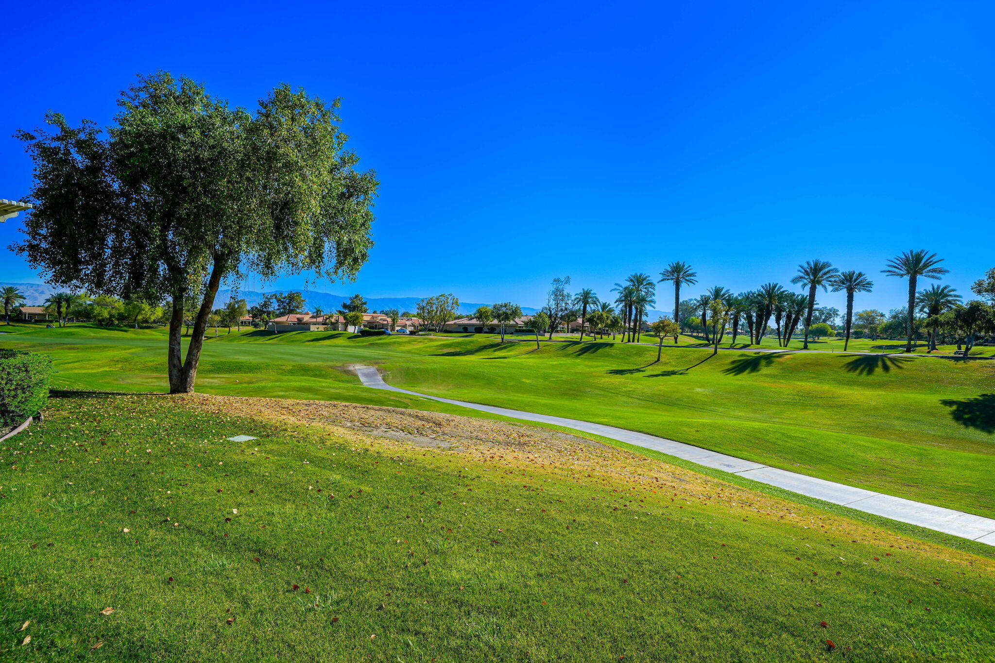 55 Colonial Drive Rancho Mirage, CA 92270 - Photo 20 of 31 a view of a golf course with a lake
