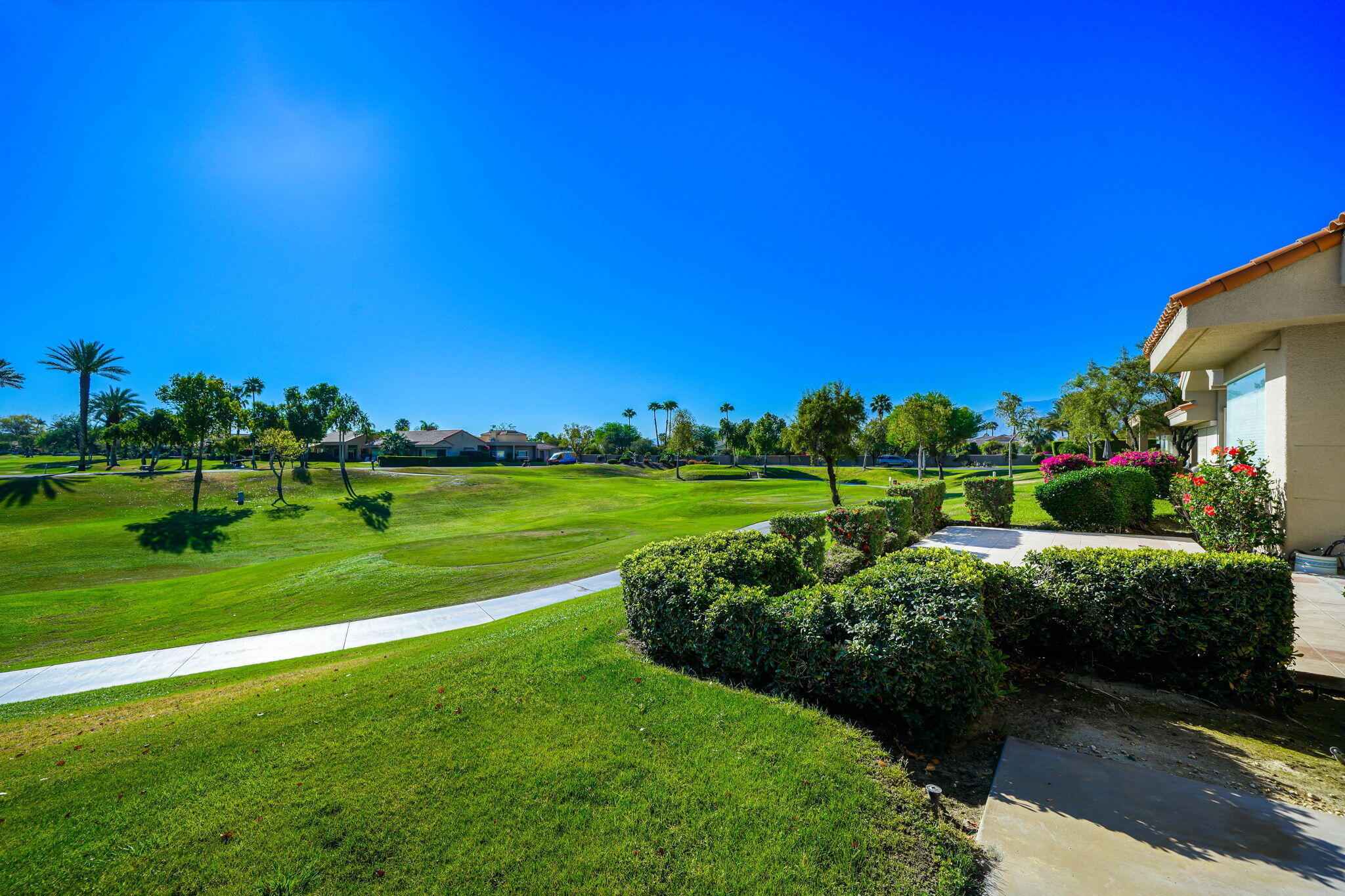 55 Colonial Drive Rancho Mirage, CA 92270 - Photo 2 of 31 a view of a golf course with a garden