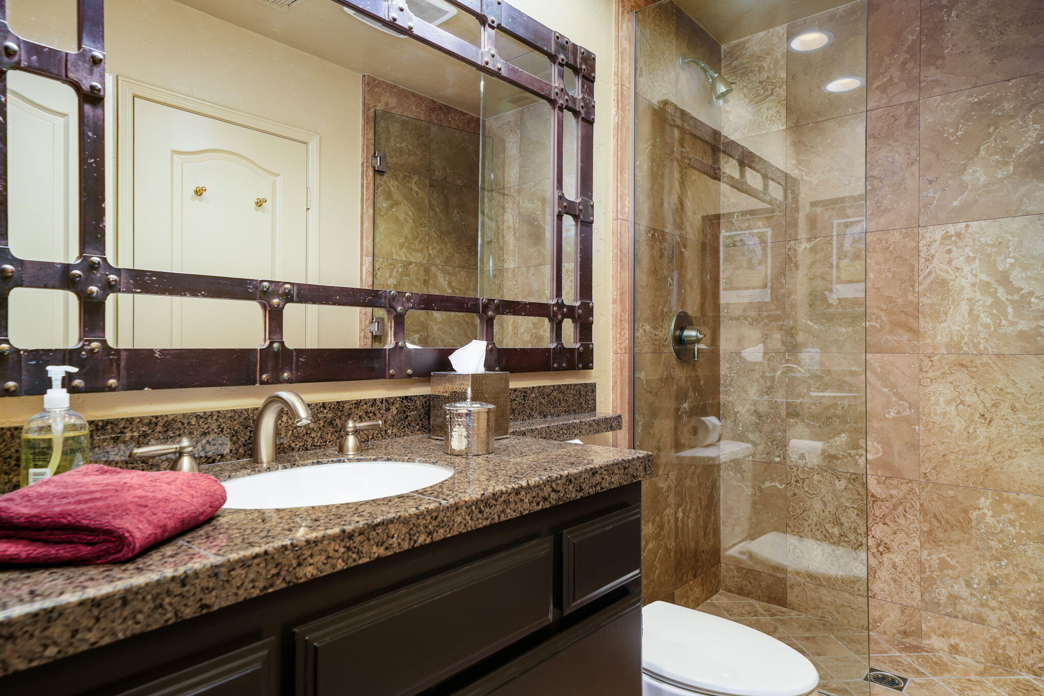 55 Colonial Drive Rancho Mirage, CA 92270 - Photo 26 of 31 a bathroom with a granite countertop sink a toilet a mirror and shower