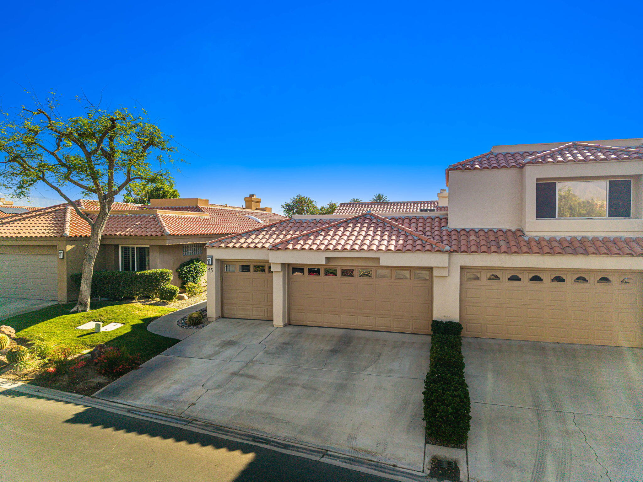 55 Colonial Drive Rancho Mirage, CA 92270 - Photo 29 of 31 a front view of a house with a garage