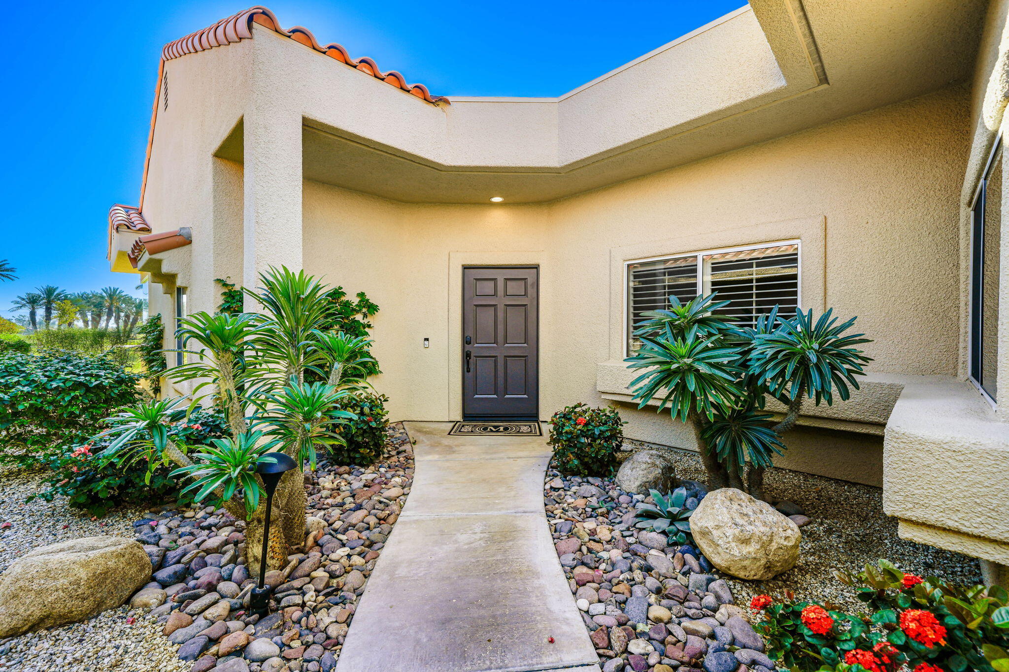 55 Colonial Drive Rancho Mirage, CA 92270 - Photo 5 of 31 a front view of a house with plants
