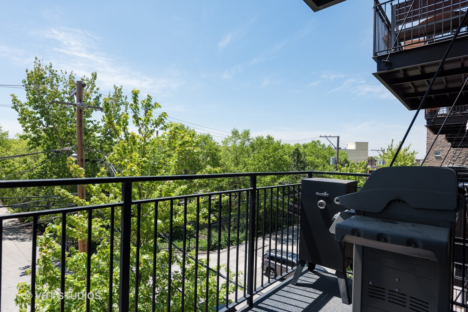1909 West Diversey Parkway, Unit 302 Chicago, IL 60614 - Photo 12 of 12 a view of a balcony with chairs and wooden fence