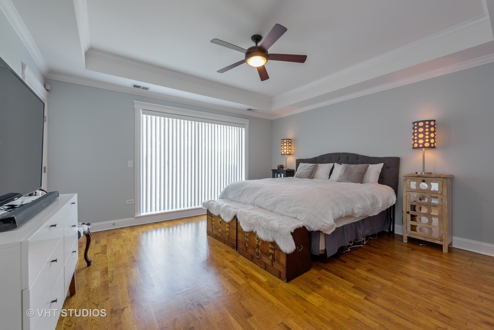 1909 West Diversey Parkway, Unit 302 Chicago, IL 60614 - Photo 6 of 12 a spacious bedroom with a bed and a ceiling fan