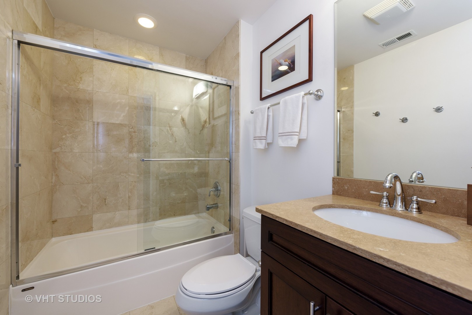 1909 West Diversey Parkway, Unit 302 Chicago, IL 60614 - Photo 10 of 12 a bathroom with a granite countertop sink a toilet and shower