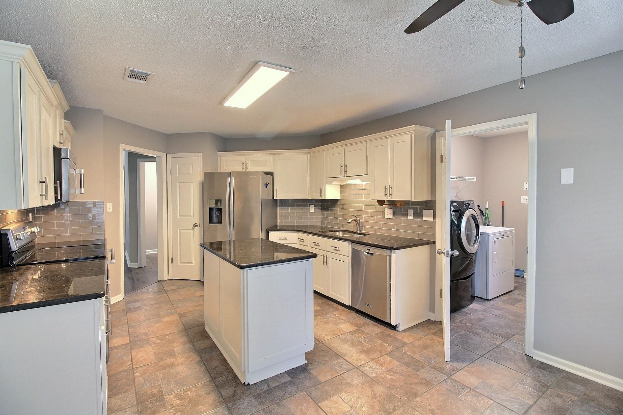 244 Saybrook Cove Collierville, TN 38017 - Photo 9 of 28 a kitchen with stainless steel appliances granite countertop a refrigerator and a stove top oven