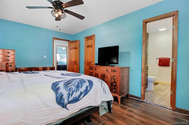a bathroom with a sink a toilet and mirror