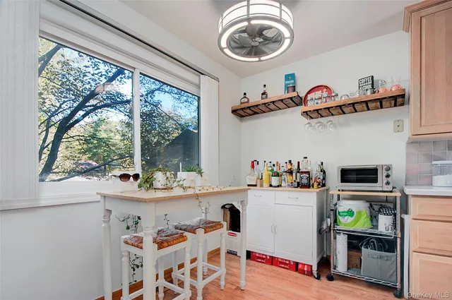 a view of a dining room with furniture a rug and wooden floor