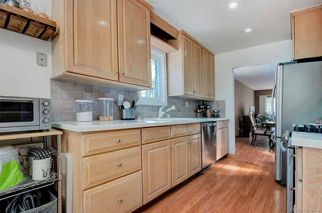 a kitchen with stainless steel appliances a sink stove and cabinets