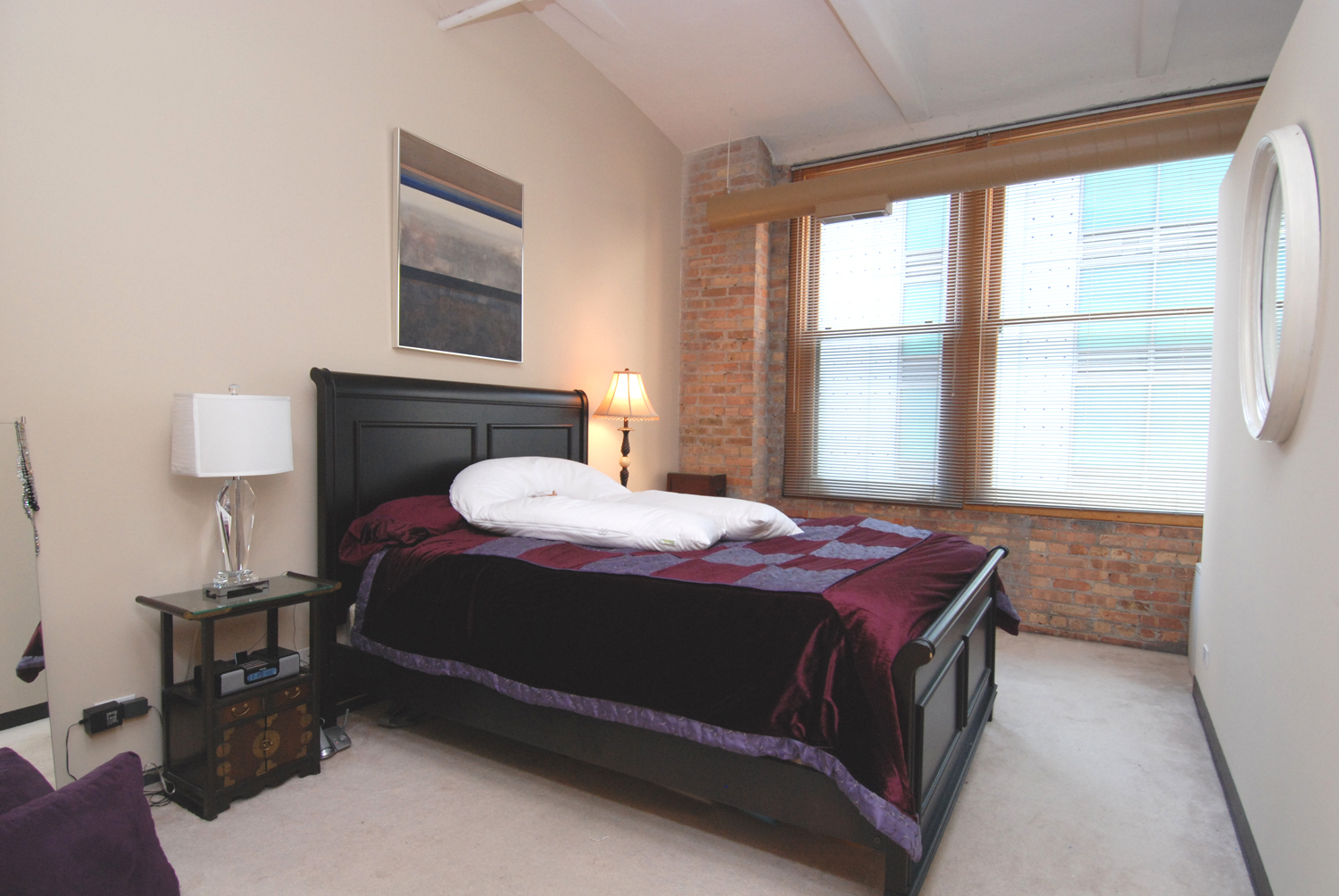 801 South Wells Street, Unit 311 Chicago, IL 60607 - Photo 11 of 16 a bedroom with a bed lamp and window