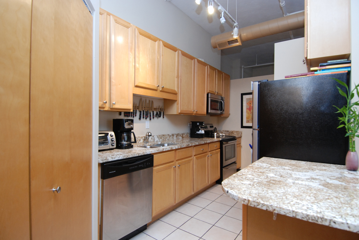 801 South Wells Street, Unit 311 Chicago, IL 60607 - Photo 6 of 16 a kitchen with stainless steel appliances granite countertop a sink stove and refrigerator