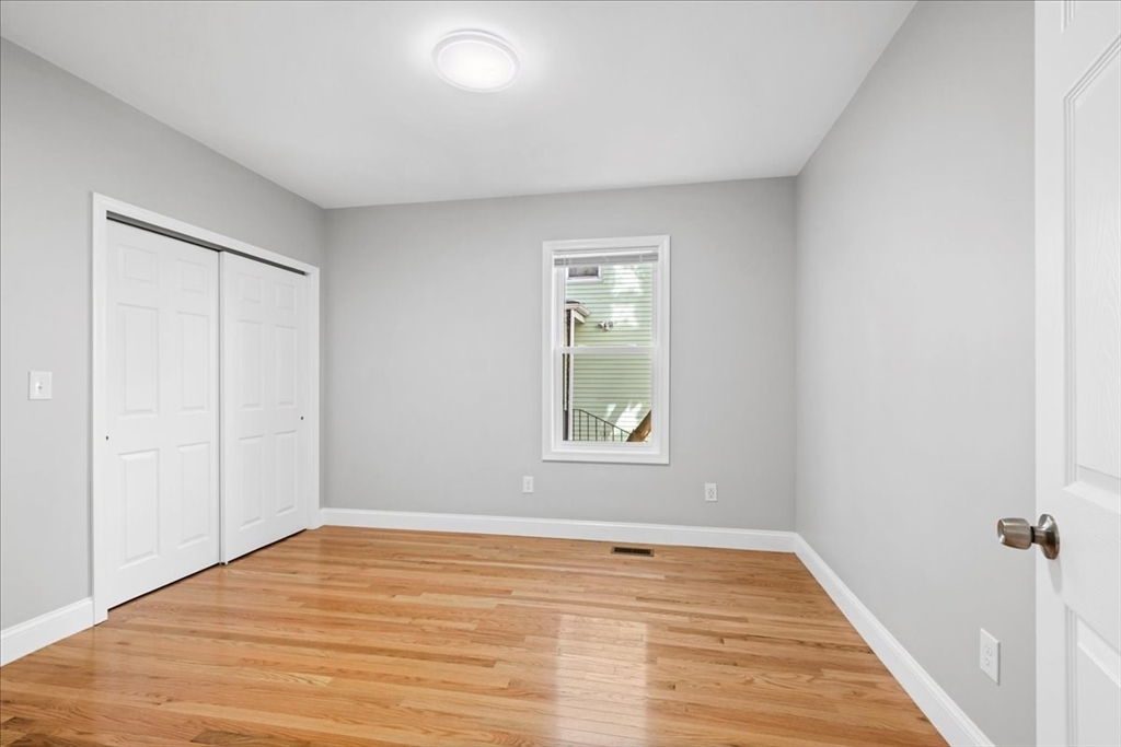 9 Upsala Street, Unit 2 Worcester, MA 01610 - Photo 12 of 29 a view of empty room with wooden floor and fan