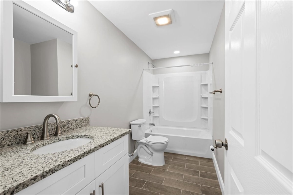 9 Upsala Street, Unit 2 Worcester, MA 01610 - Photo 13 of 29 a bathroom with a granite countertop sink a toilet and shower