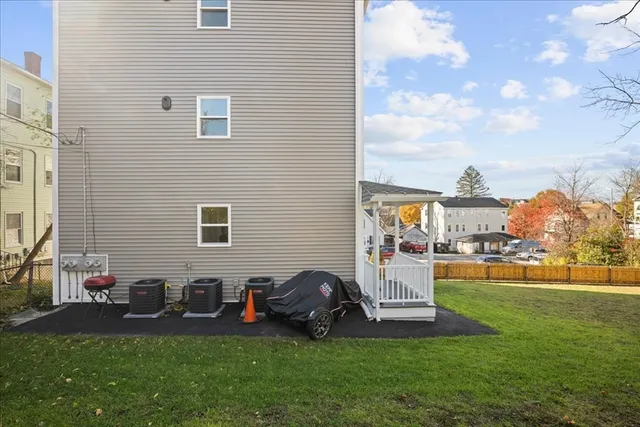 a backyard of a house with table and chairs
