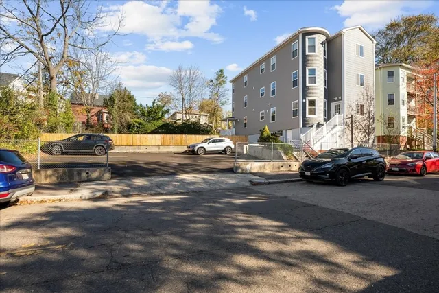 a row of cars parked in front of a house