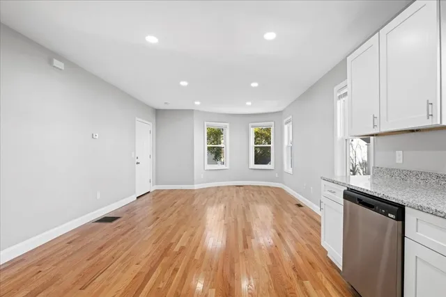 a view of kitchen with granite countertop cabinets and wooden floor