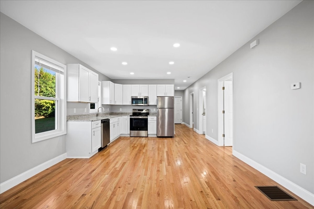 9 Upsala Street, Unit 2 Worcester, MA 01610 - Photo 6 of 29 a kitchen with stainless steel appliances granite countertop a refrigerator and a stove top oven