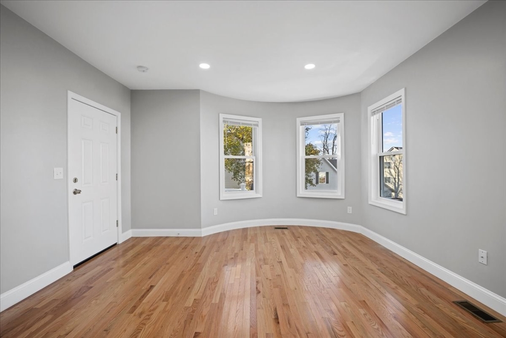 9 Upsala Street, Unit 2 Worcester, MA 01610 - Photo 8 of 29 a view of empty room with wooden floor and fan