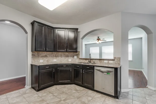an empty room with closet and a chandelier fan