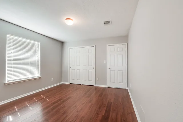 a bathroom with a granite countertop sink toilet a large mirror a bathtub and shower