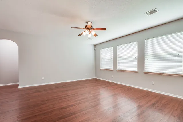 wooden floor in an empty room with a window