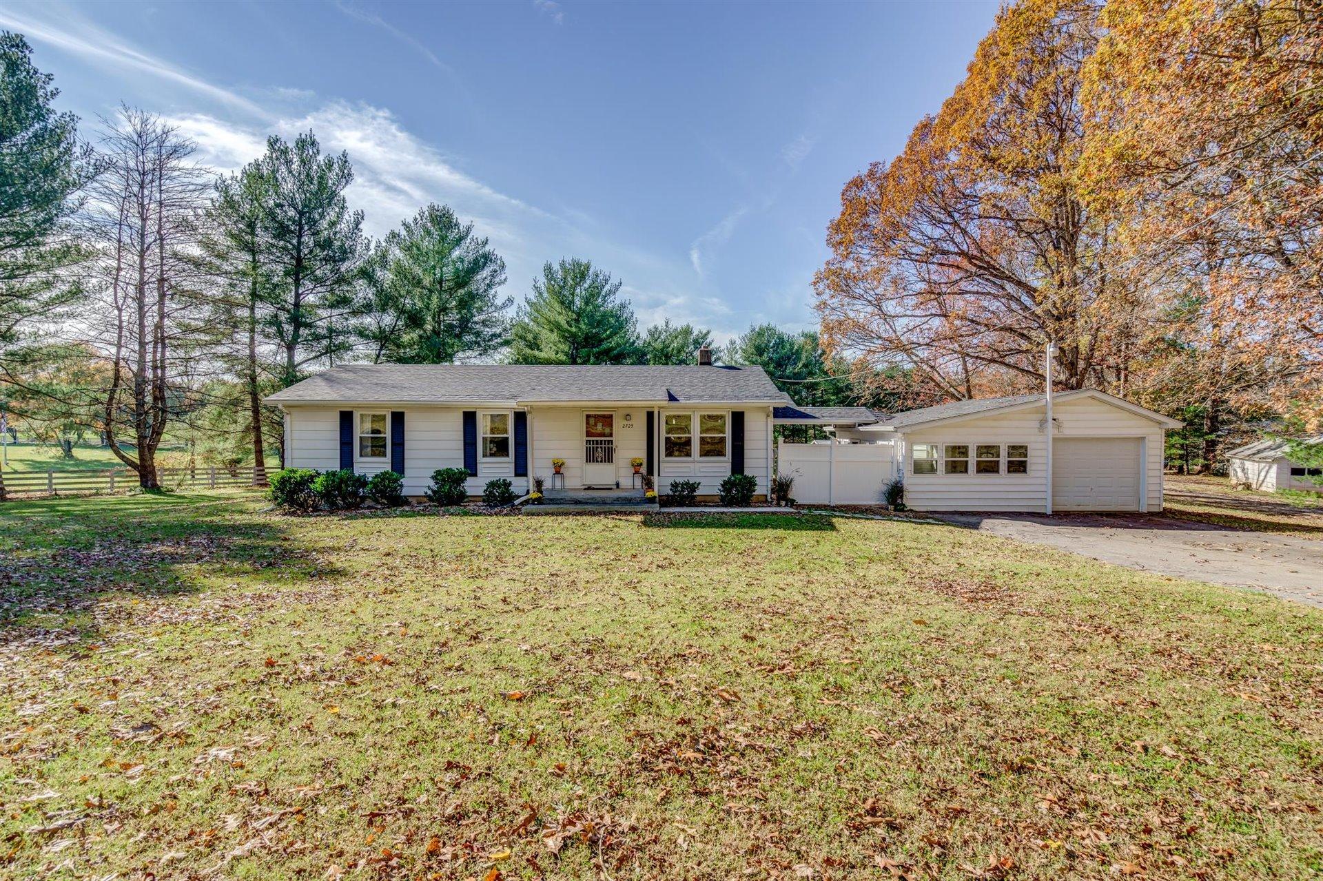 2725 Morgans Mill Road Goodview, VA 24095 - Photo 1 of 49 a front view of a house with a garden and trees