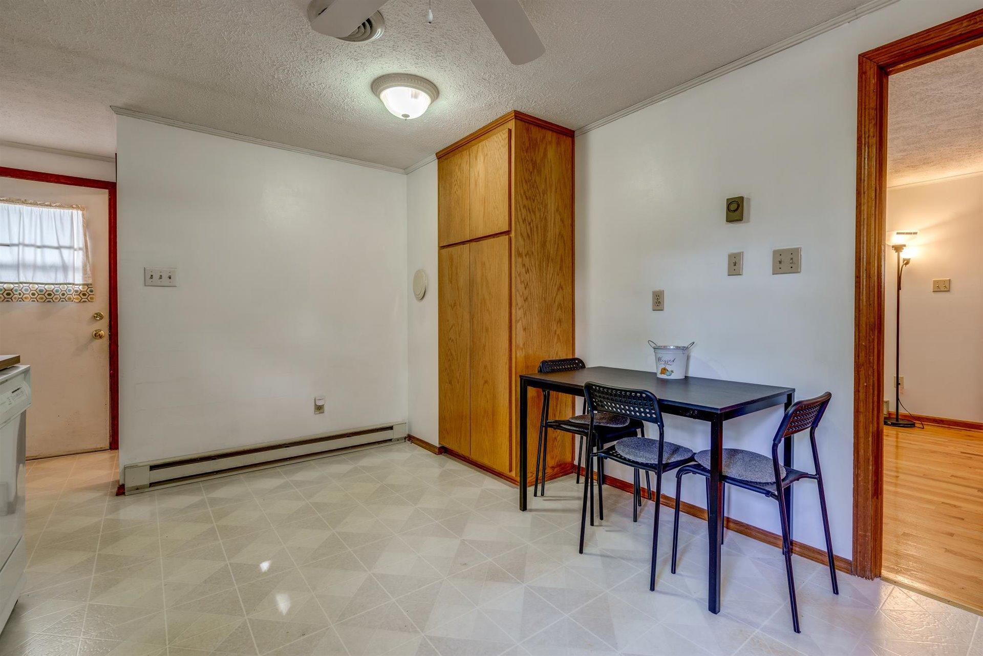 2725 Morgans Mill Road Goodview, VA 24095 - Photo 11 of 49 an empty room with furniture and wooden floor