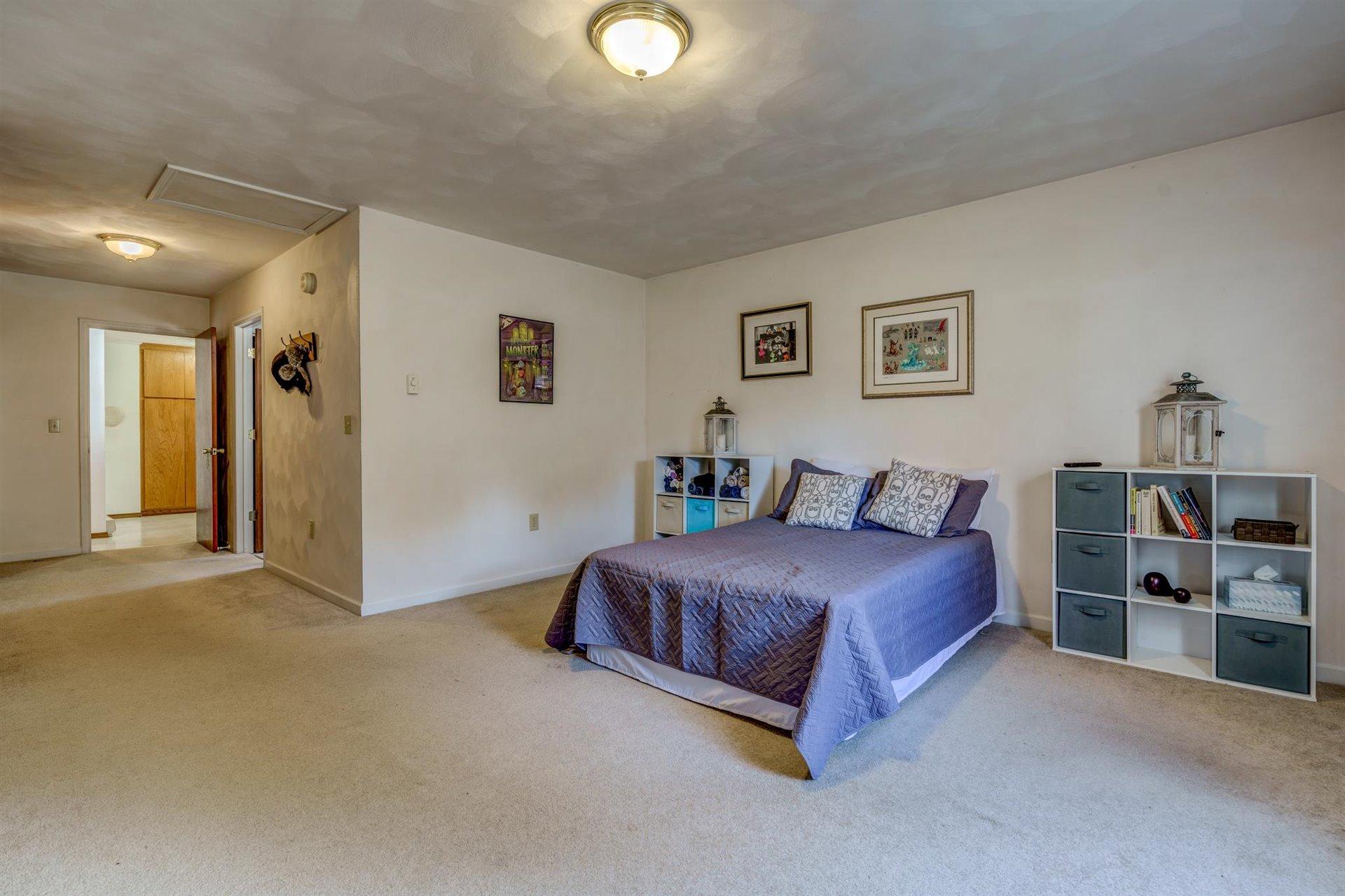 2725 Morgans Mill Road Goodview, VA 24095 - Photo 14 of 49 a spacious bedroom with a bed and closet