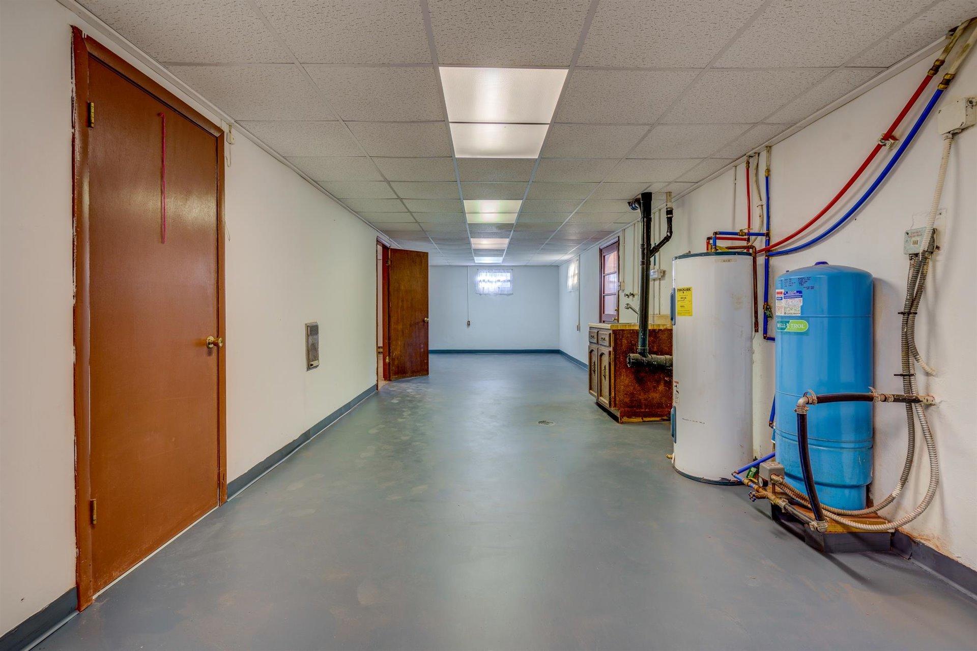 2725 Morgans Mill Road Goodview, VA 24095 - Photo 33 of 49 a view of a hallway with gym equipment