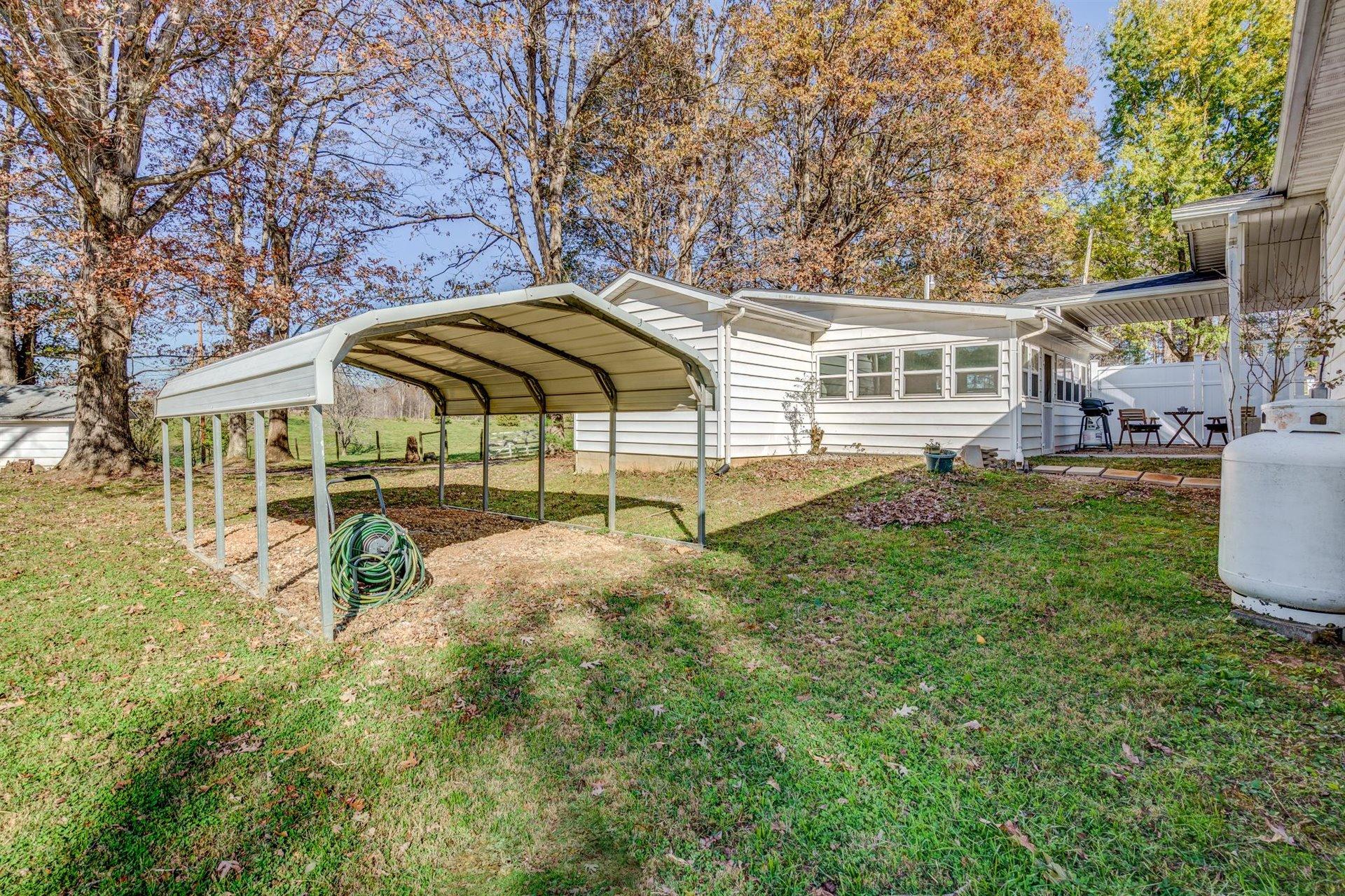 2725 Morgans Mill Road Goodview, VA 24095 - Photo 39 of 49 a view of a house with backyard and sitting area