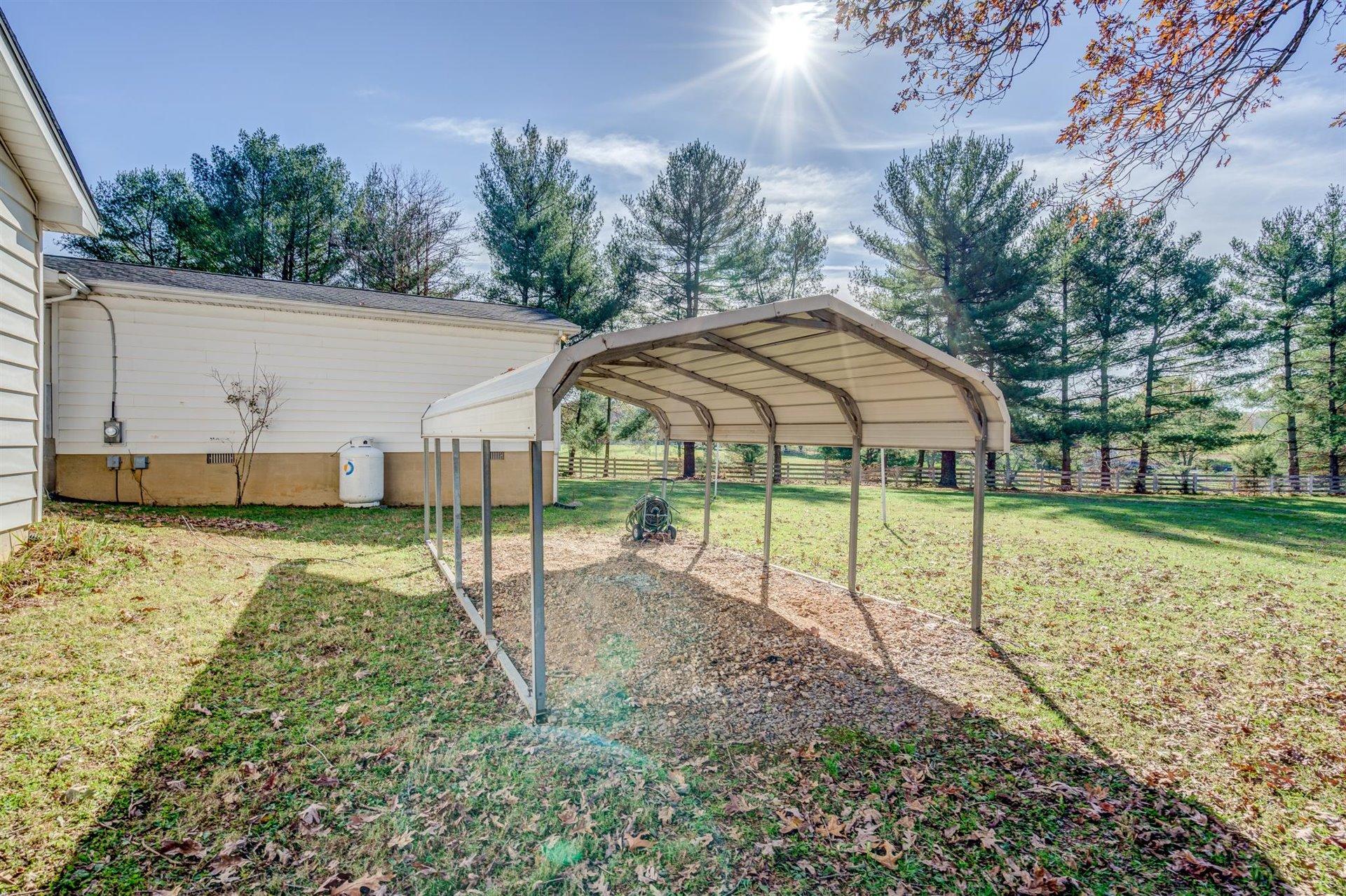 2725 Morgans Mill Road Goodview, VA 24095 - Photo 41 of 49 a view of a garden with a slide and a lake view