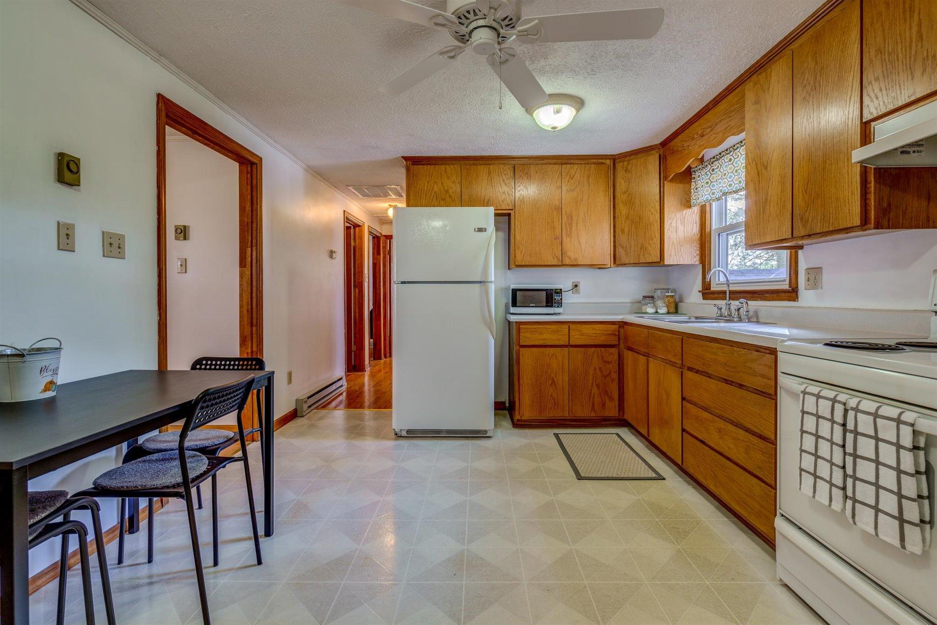 2725 Morgans Mill Road Goodview, VA 24095 - Photo 10 of 49 a kitchen with stainless steel appliances a sink cabinets and wooden floor