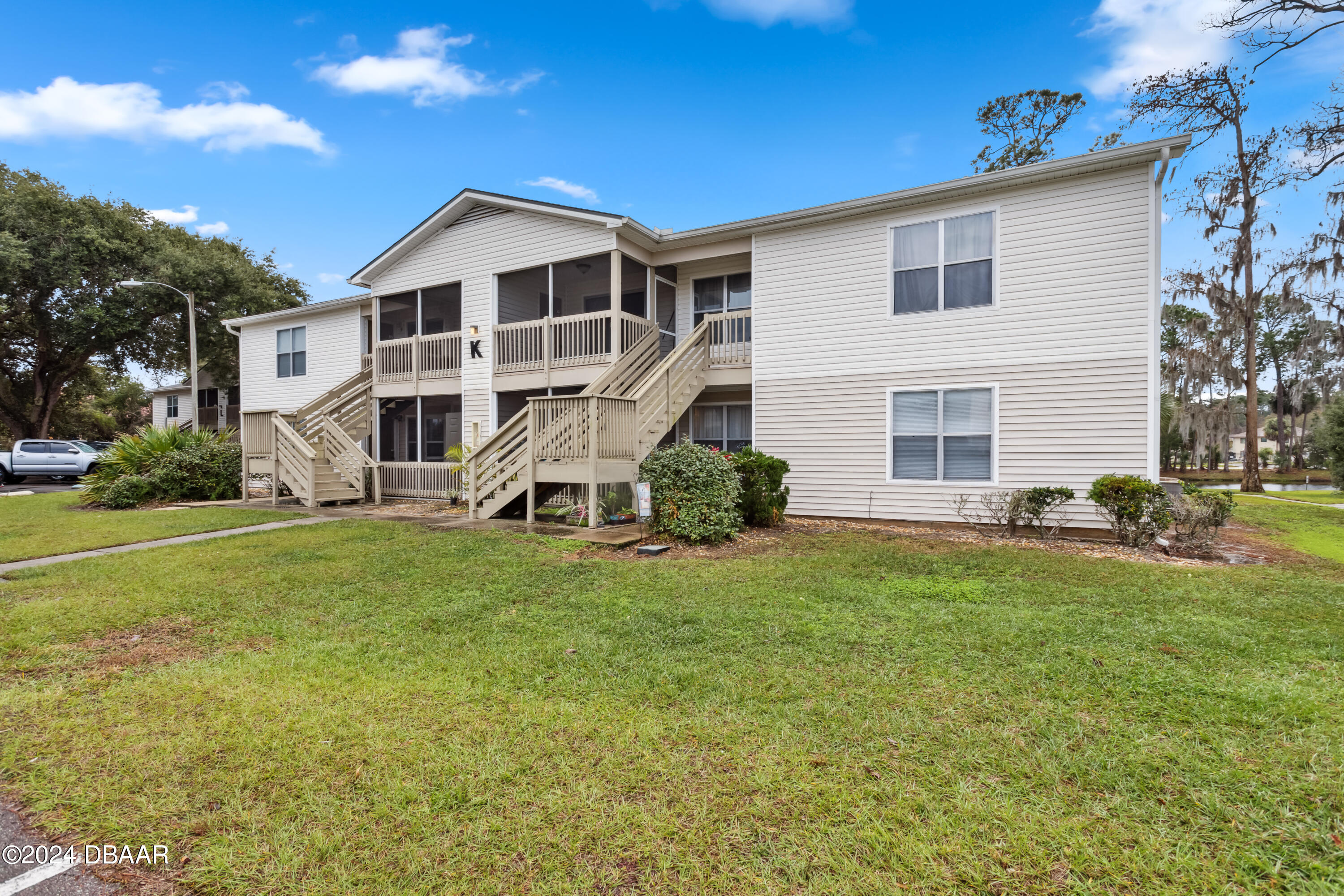 1600 Big Tree Road, Unit K1 South Daytona, FL 32119 - Photo 1 of 28 a view of a house with a yard
