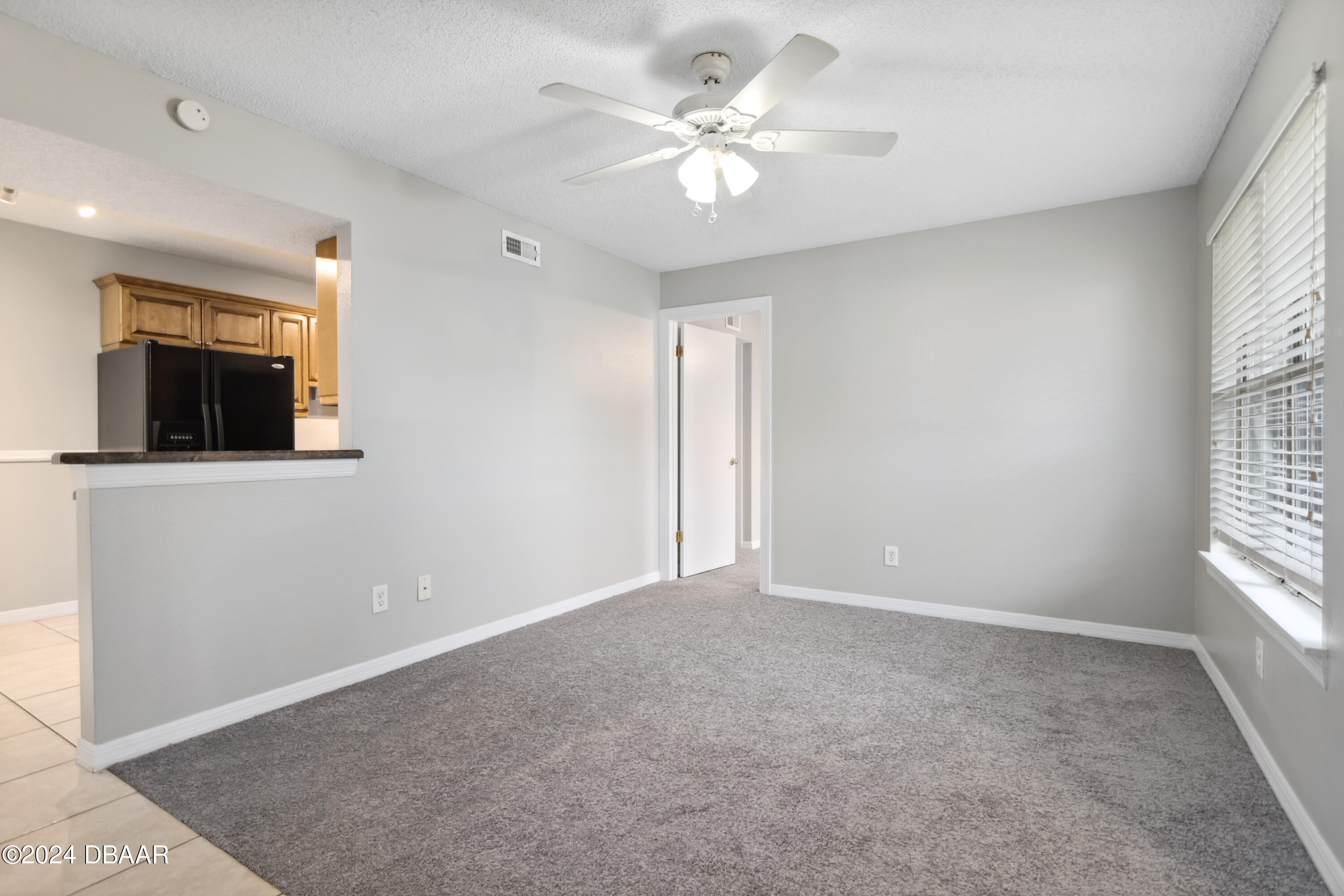 1600 Big Tree Road, Unit K1 South Daytona, FL 32119 - Photo 11 of 28 an empty room with windows and fan