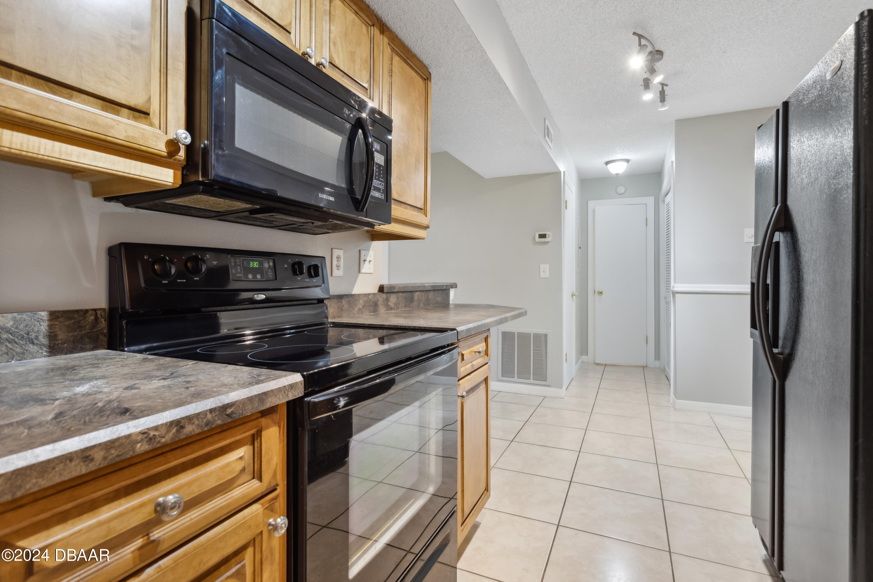 1600 Big Tree Road, Unit K1 South Daytona, FL 32119 - Photo 13 of 28 a kitchen with stainless steel appliances granite countertop a stove a refrigerator and a microwave