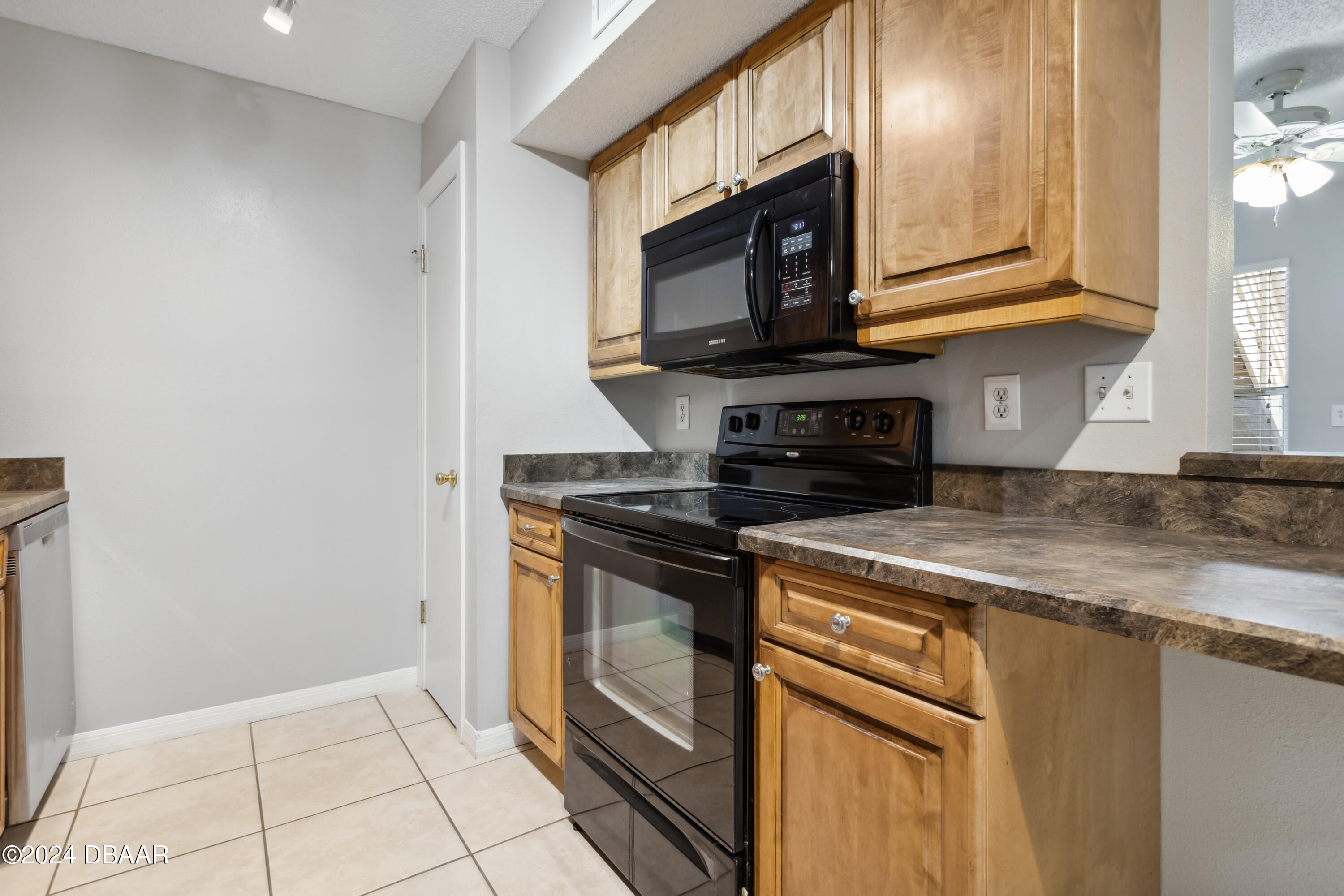 1600 Big Tree Road, Unit K1 South Daytona, FL 32119 - Photo 14 of 28 a kitchen with stainless steel appliances granite countertop a stove microwave and sink
