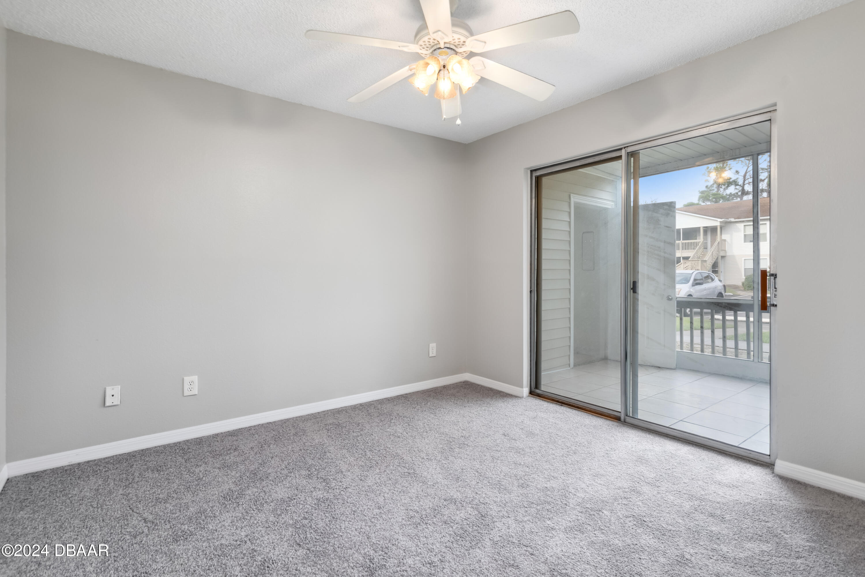1600 Big Tree Road, Unit K1 South Daytona, FL 32119 - Photo 16 of 28 en empty room with windows and fan
